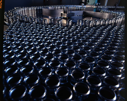 Empty inhaler canisters entering the filling machine, 1980s