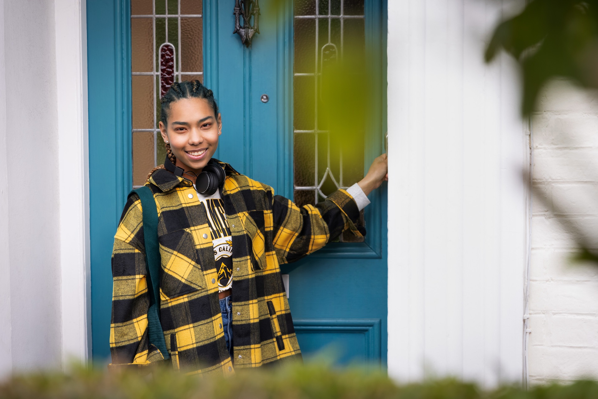 Person smiling while entering their home
