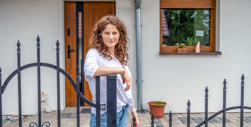 Natalia standing by gate