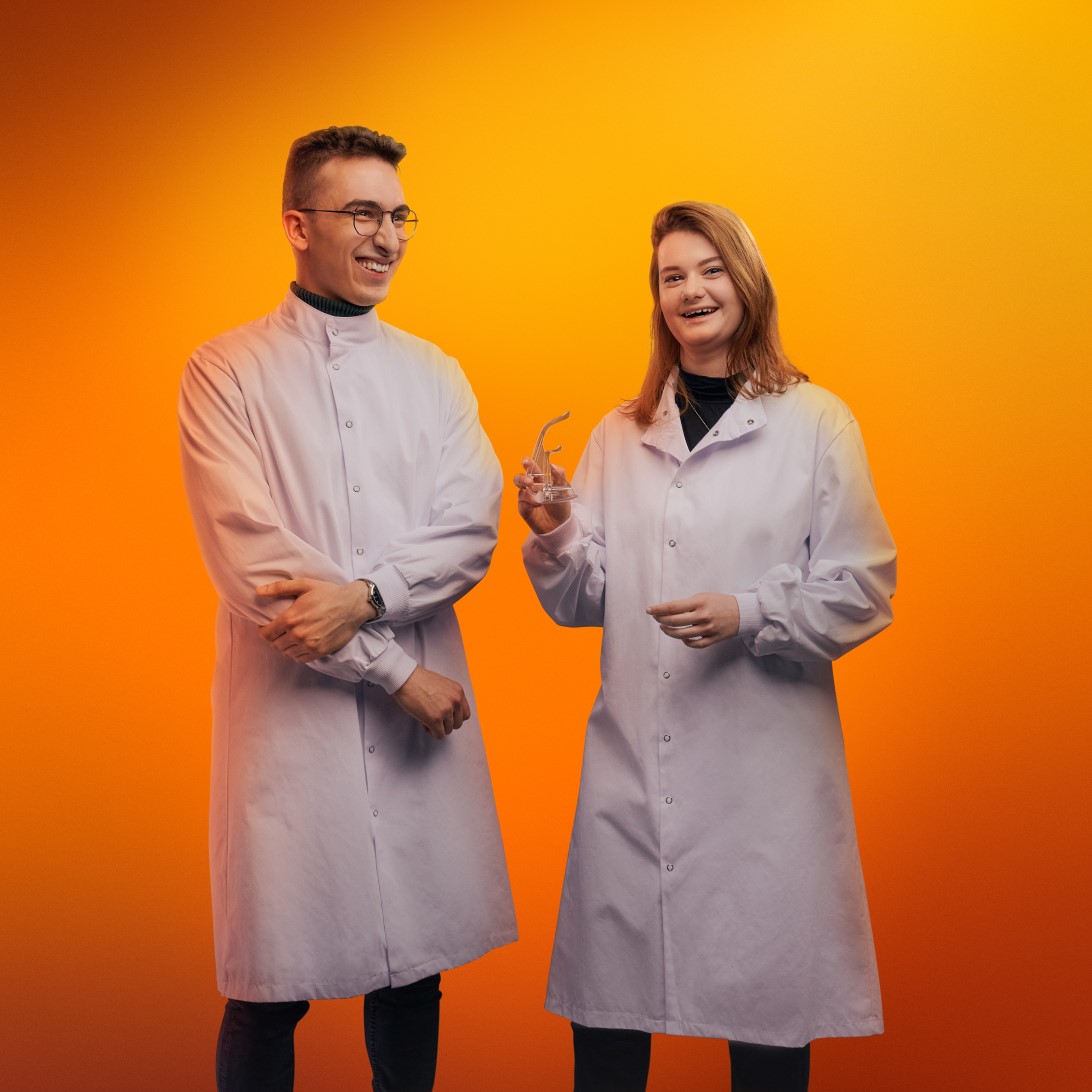 Two scientists on an orange background