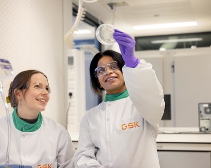 two microbiologists looking at an agar plate