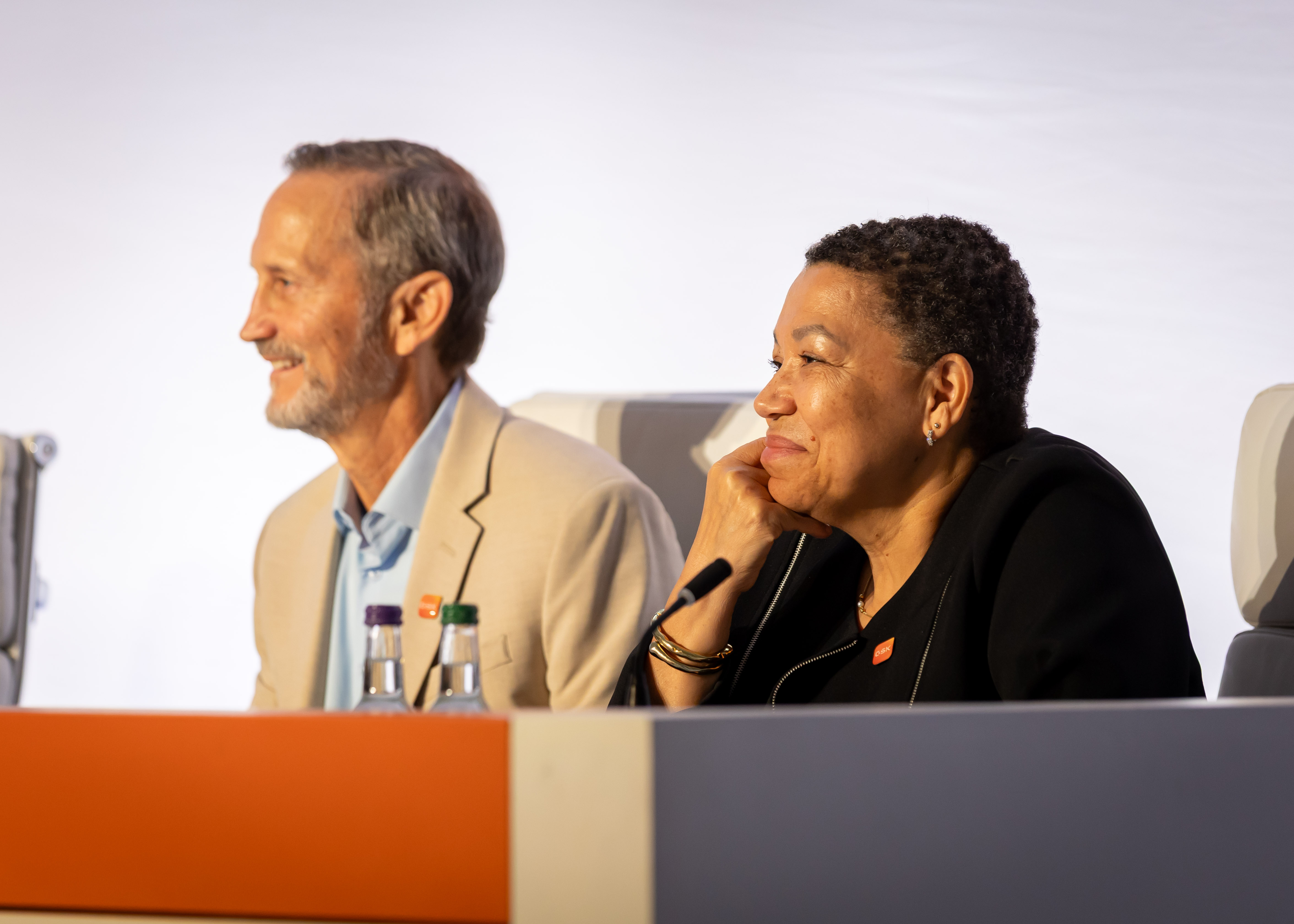 Board members Anne Beal and Charles Bancroft smile at audience at AGM