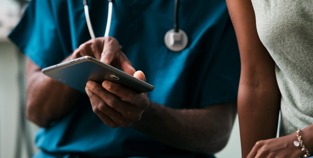 Healthcare professional shows patient information on device
