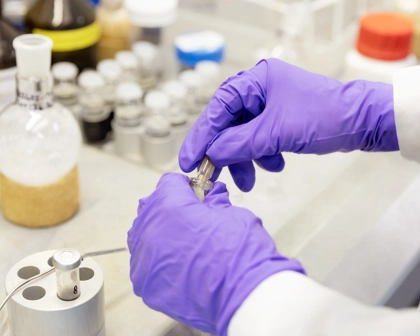 Scientist in the lab with globes on