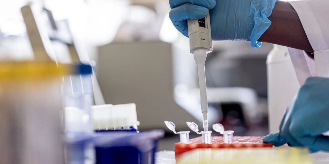 scientist using a pipette