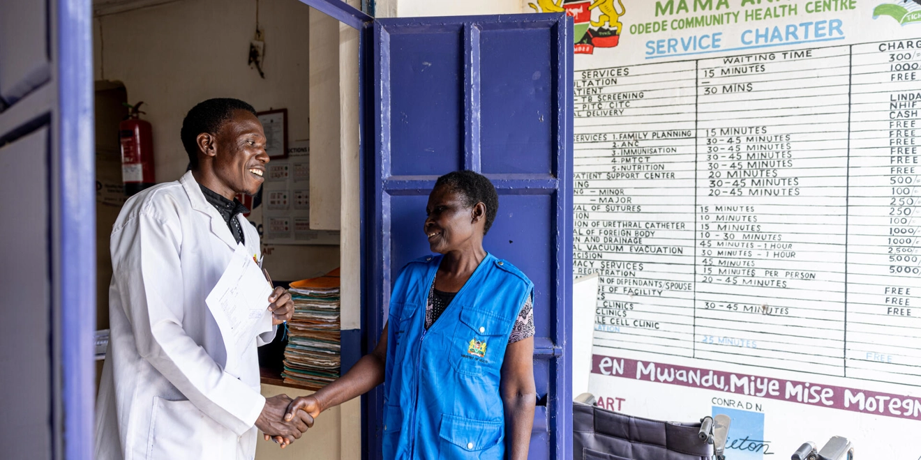 Doctor shaking hands with Community Health Extension Worker