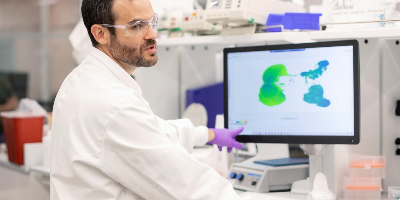 Scientist points at computer screen