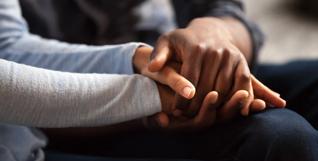 Two people holding hands