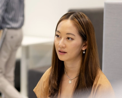 Woman works while person walks by