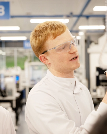 R&D scientist developing and discussing chemistry formulas in smart laboratory.