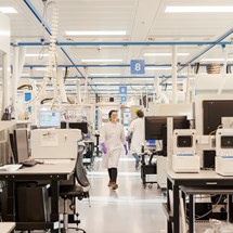 R&D scientist walking through chemistry smart lab.