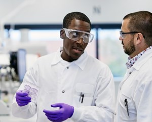 Two men talking in a lab
