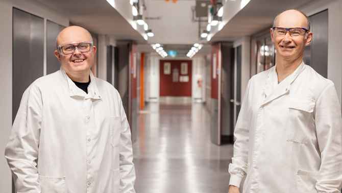 Two men smiling