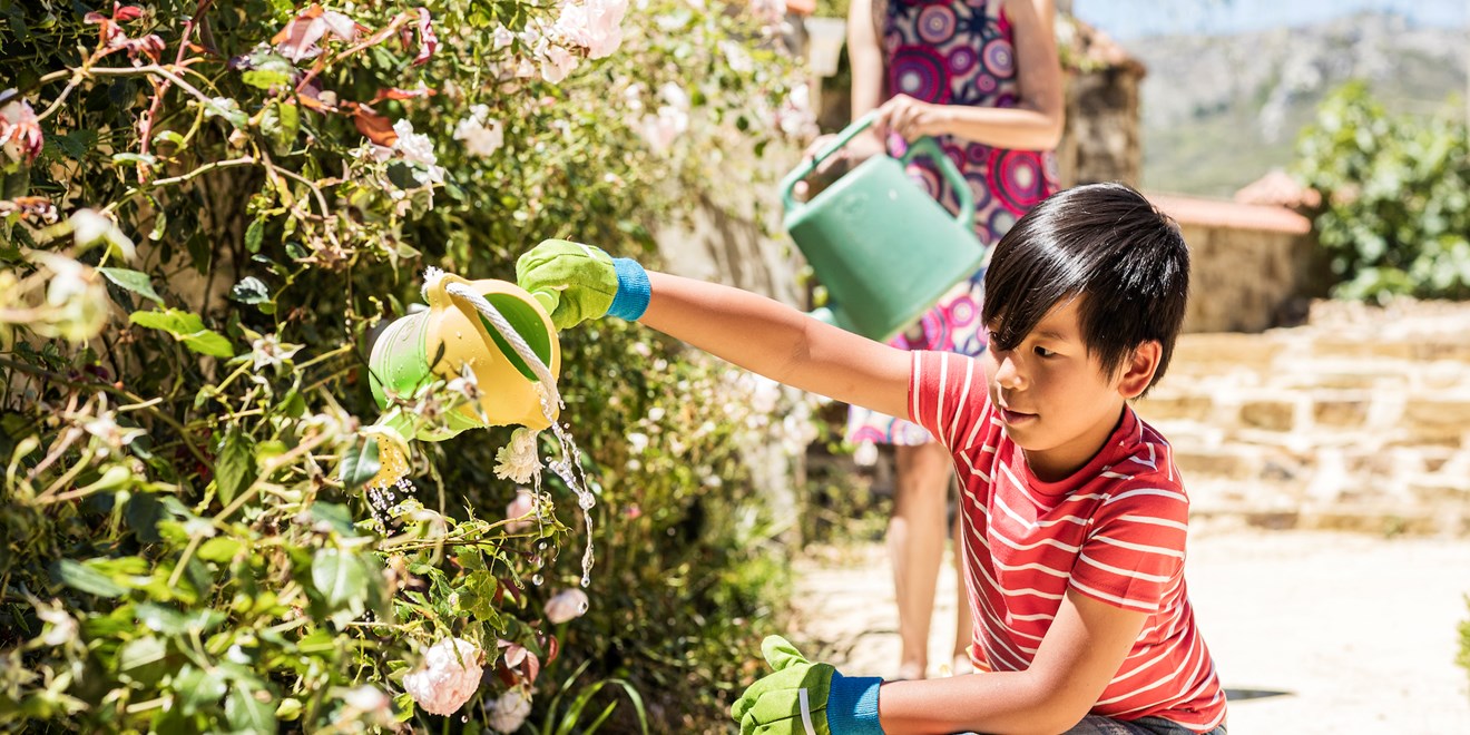 Child watering flowers