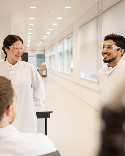 Scientists talking and laughing in a lab
