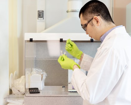 Man using a pipette in a lab