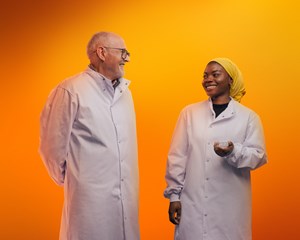 Two lab workers smiling at each other