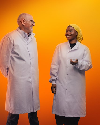 Two lab workers smiling at each other