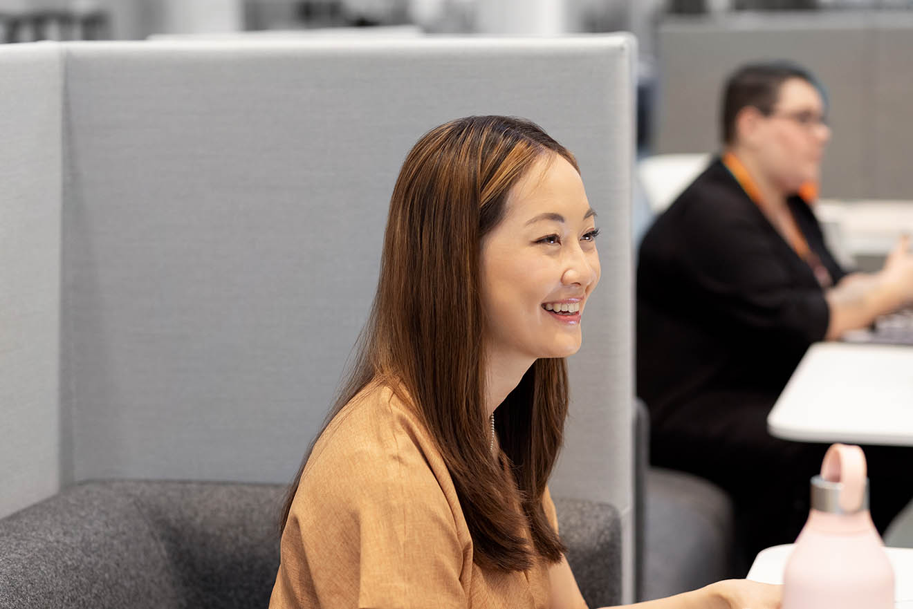 Woman at desk smiling 