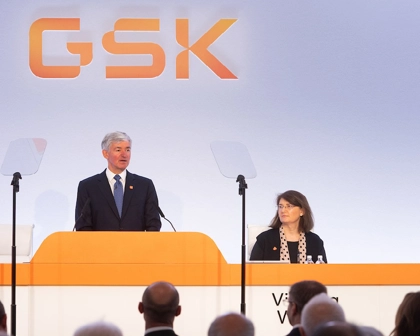 Company Secretary, Victoria Whyte, sits next to Chair, Jon Symonds as he speaks to AGM audience.