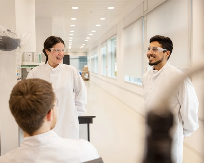 Scientists talking and laughing in a lab