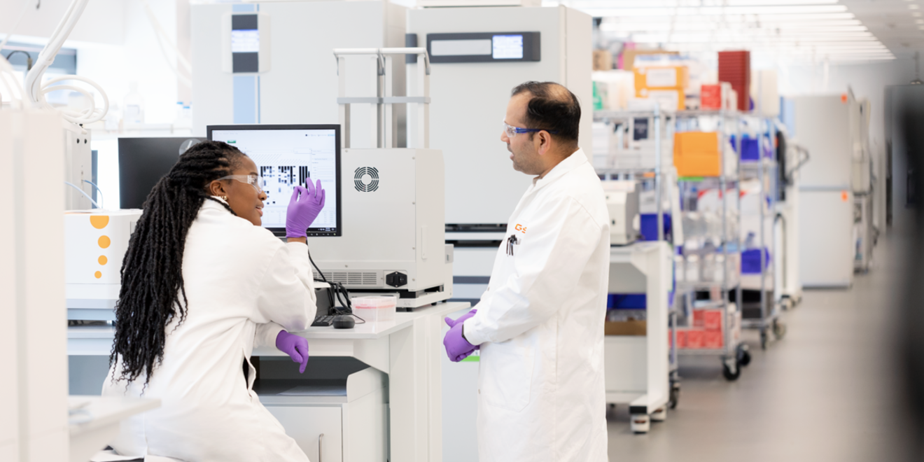 Two scientists discuss lab chart