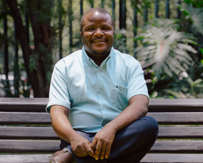 man sitting on bench and posing