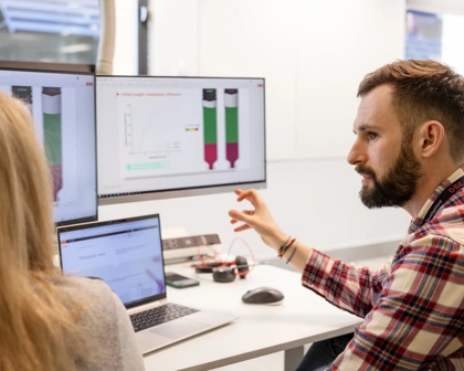 two device engineers collaborating at a screen