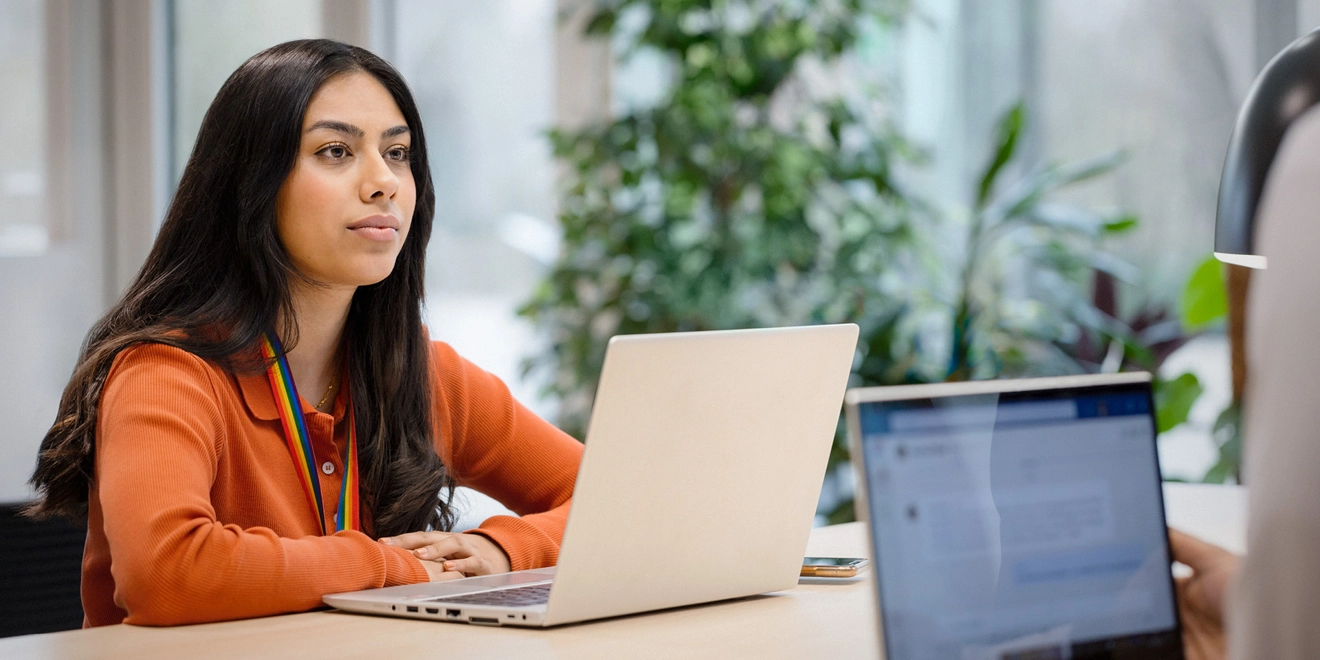 Woman listening intently to another employee