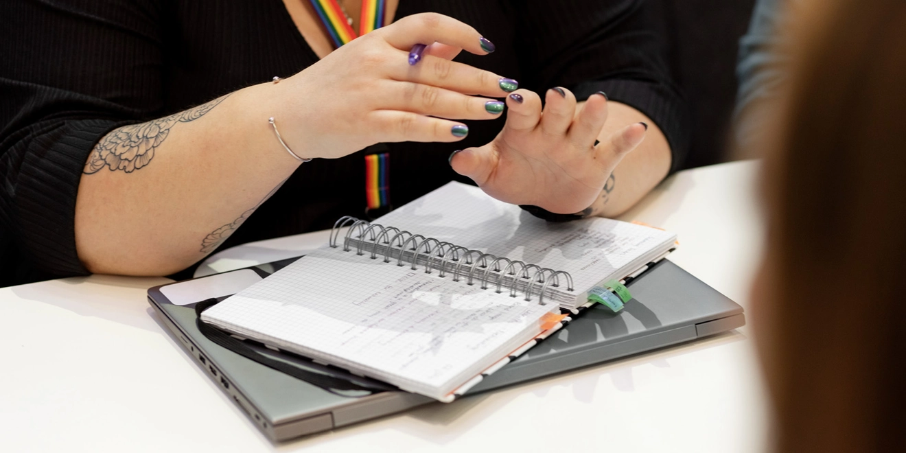 Woman holding a pencil and notepad