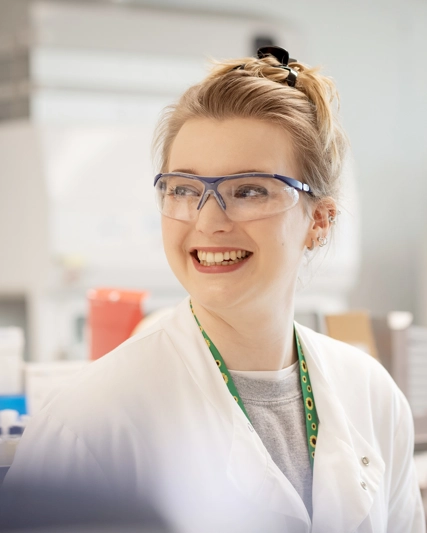 Lab worker smiling