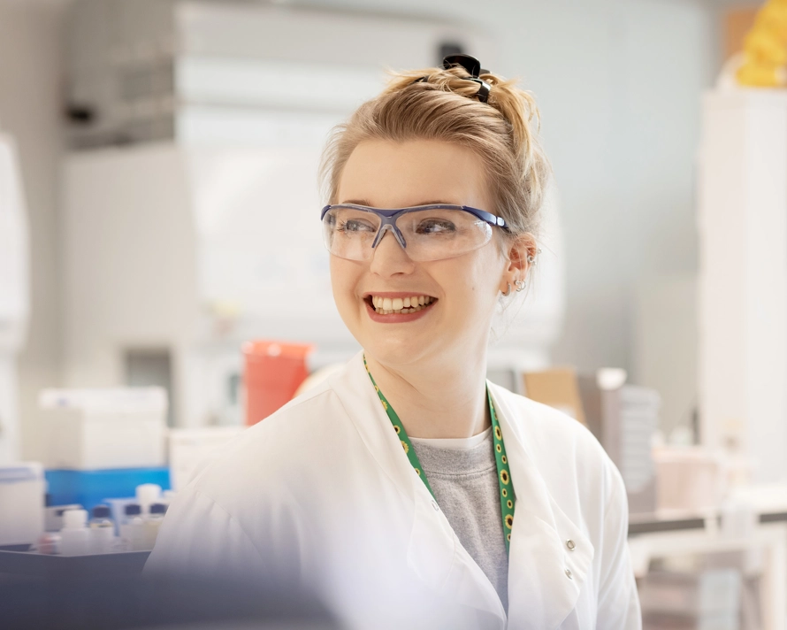 Lab worker smiling