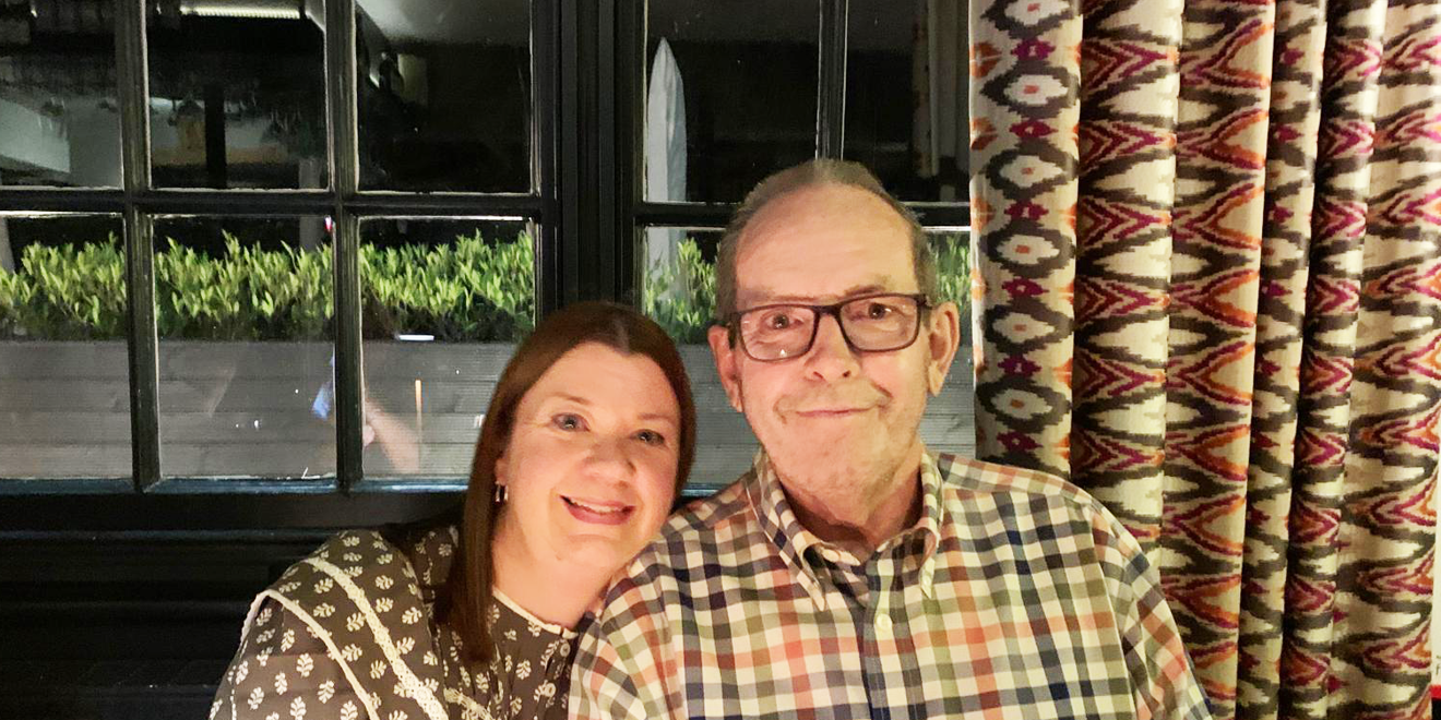 Patient and wife in front of window