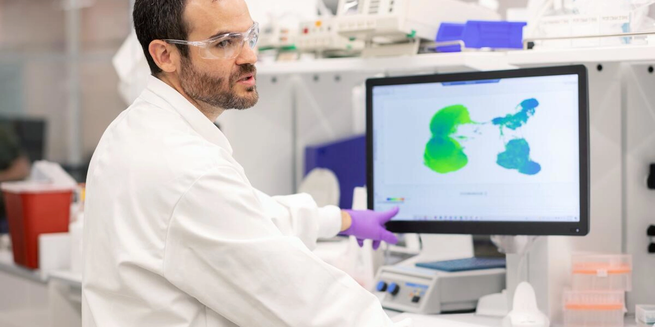 Scientist points at computer screen