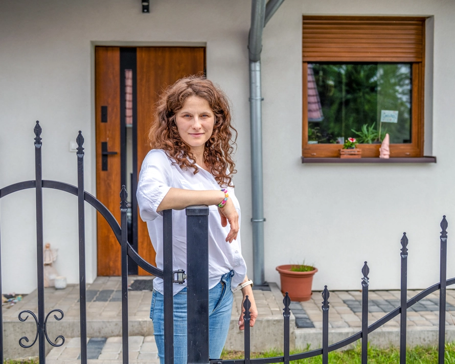 Natalia standing by gate