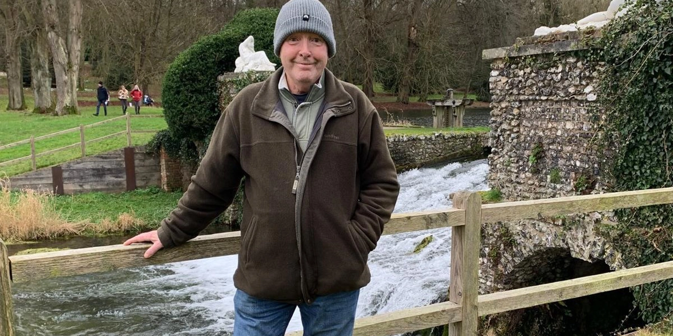 Patient standing in front of stream