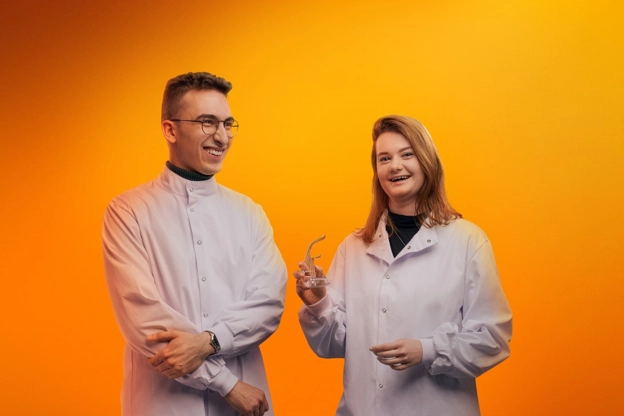 Two scientists on an orange background