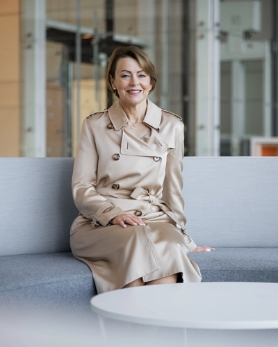 Julie Brown sat on a grey sofa smiling