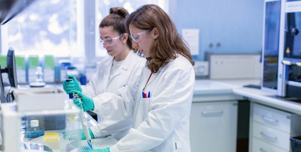 Scientists use pipettes in laboratory