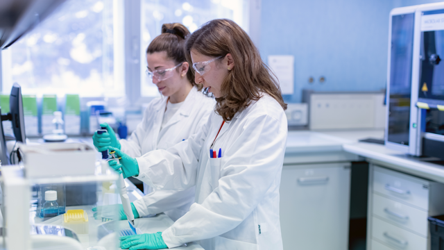 Scientists use pipettes in laboratory