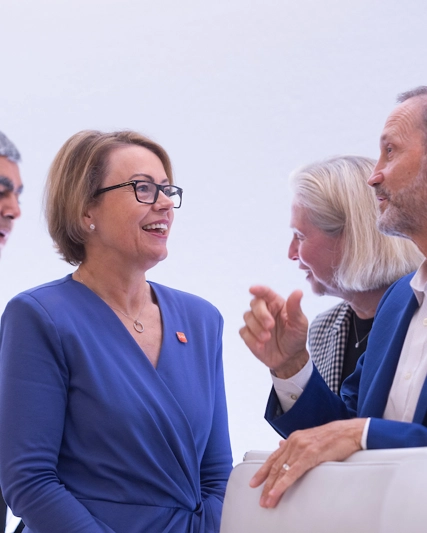 CFO Julie Brown talks to Board Director Charles Bancroft, behind stands Vishal Sikka, Liz Anderson