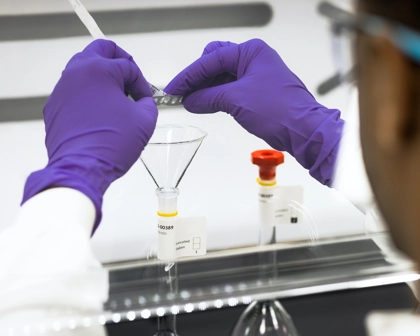 GSK quality lab operator engaged in focussed task.