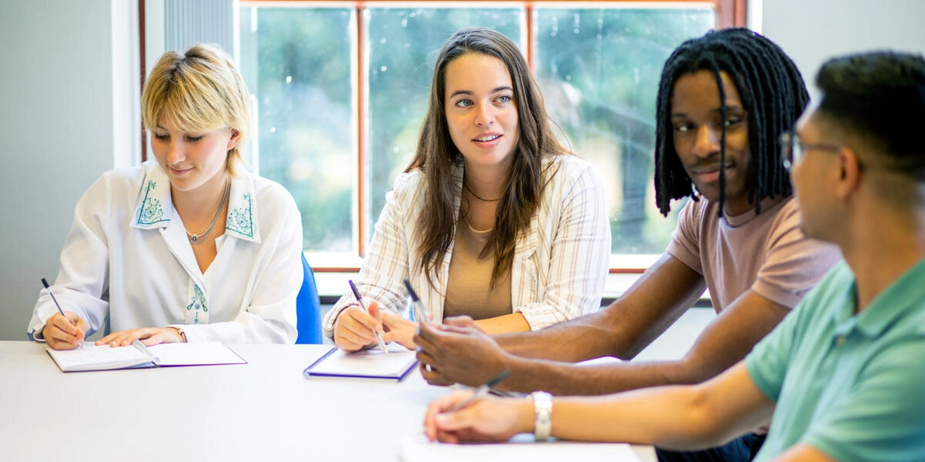Four team members meeting around a table