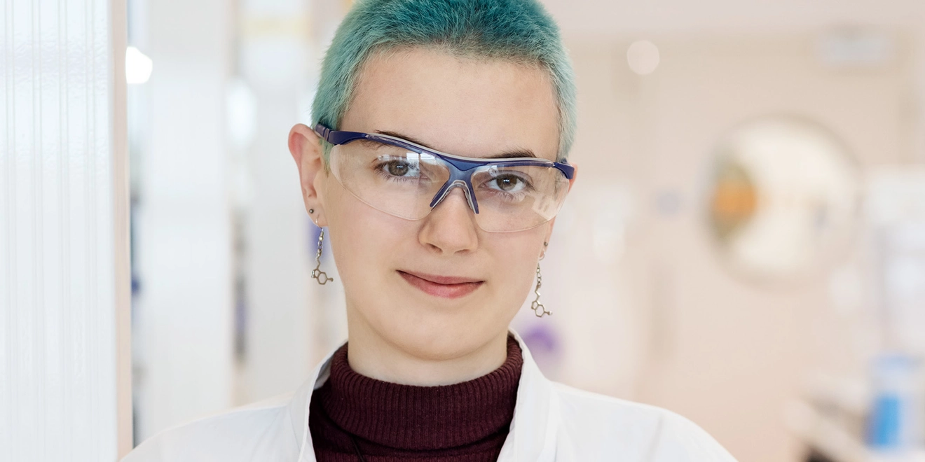 Woman in labcoat smiling