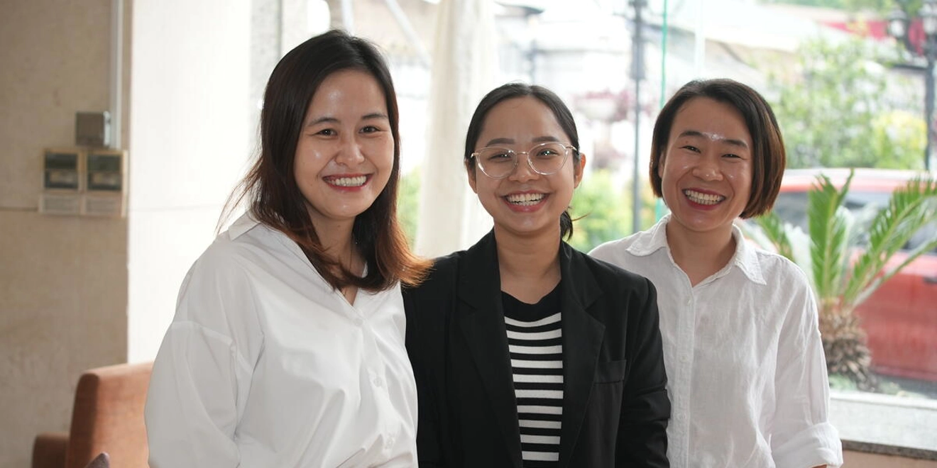 Three women smiling. Positive Action harm reduction grantees